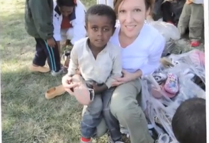 Diane Studer giving a Pair of Shoes in Ethiopia